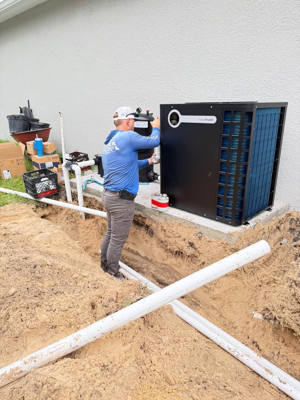 Hopper Pools team member installing pool equipment