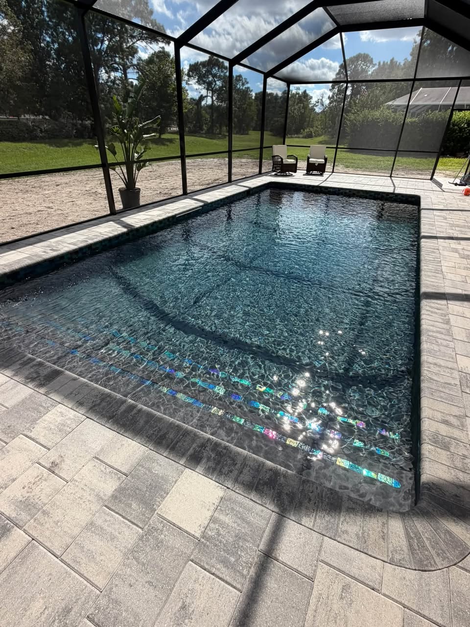 Completed swimming pool with a sun shelf and decorative tile